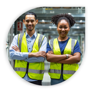 a man and woman with their arms crossed wearing safety vests in warehouse