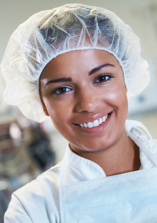 Staff Australia Employment Services 2 A food tech worker smiling wearing a hair net