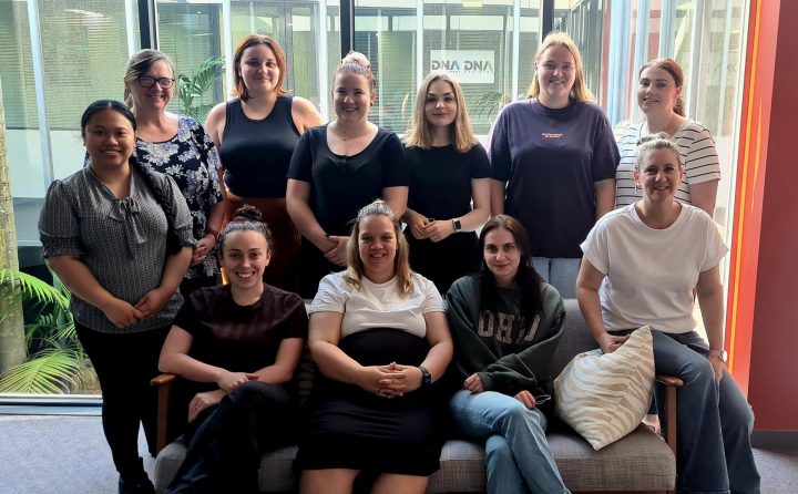 A crowd of Staff Australia women posing for a photo on International Women’s Day.