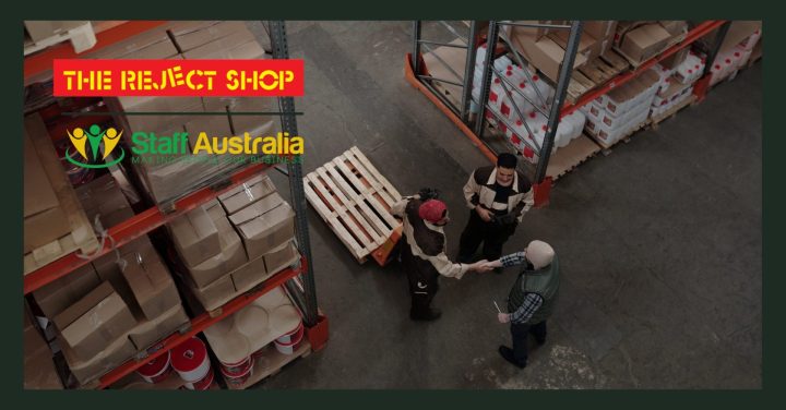 three men shaking hands in a warehouse