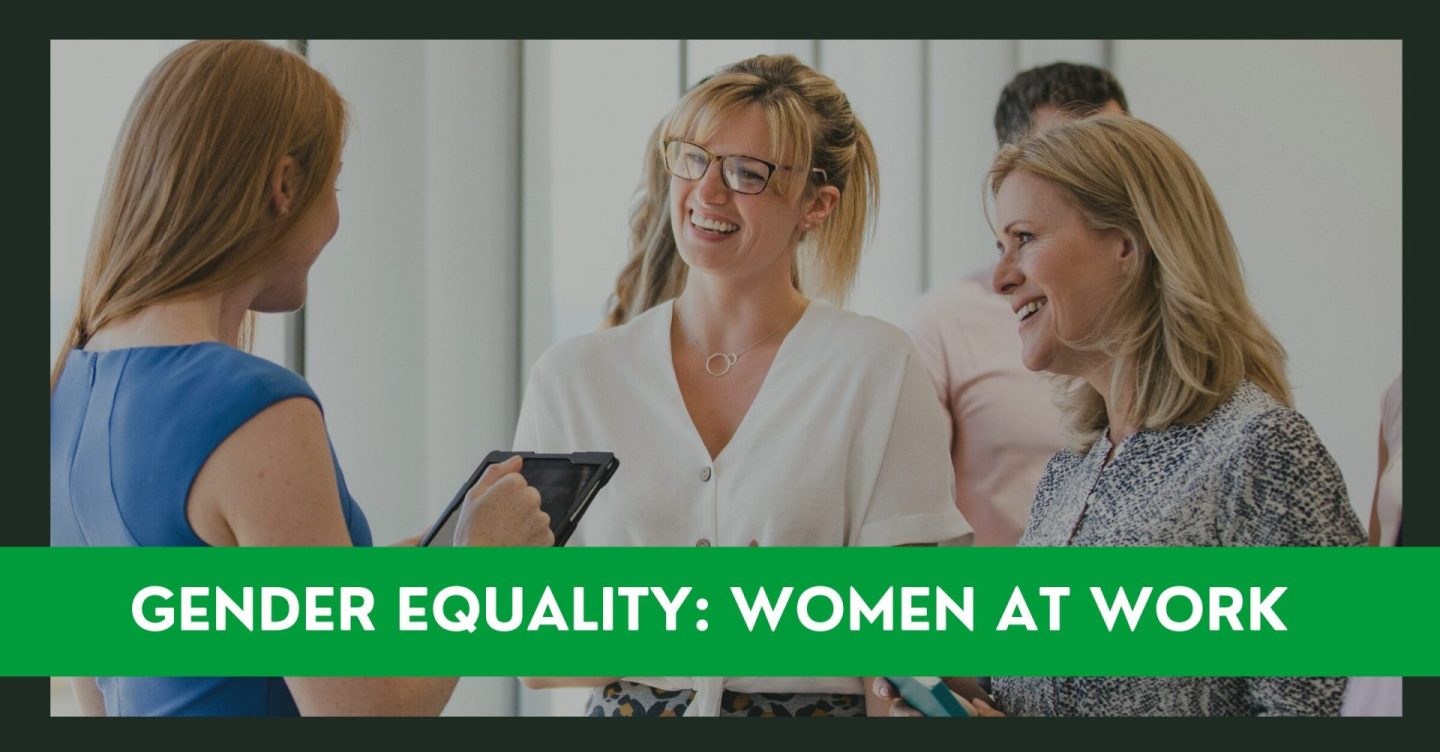 A group of women talking in an office