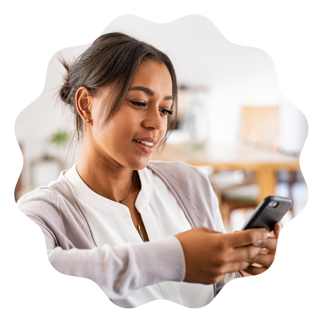 What Does the Future of Retirement Look Like? 4 Ways to Prepare 4 A woman happily smiling while looking at her phone.