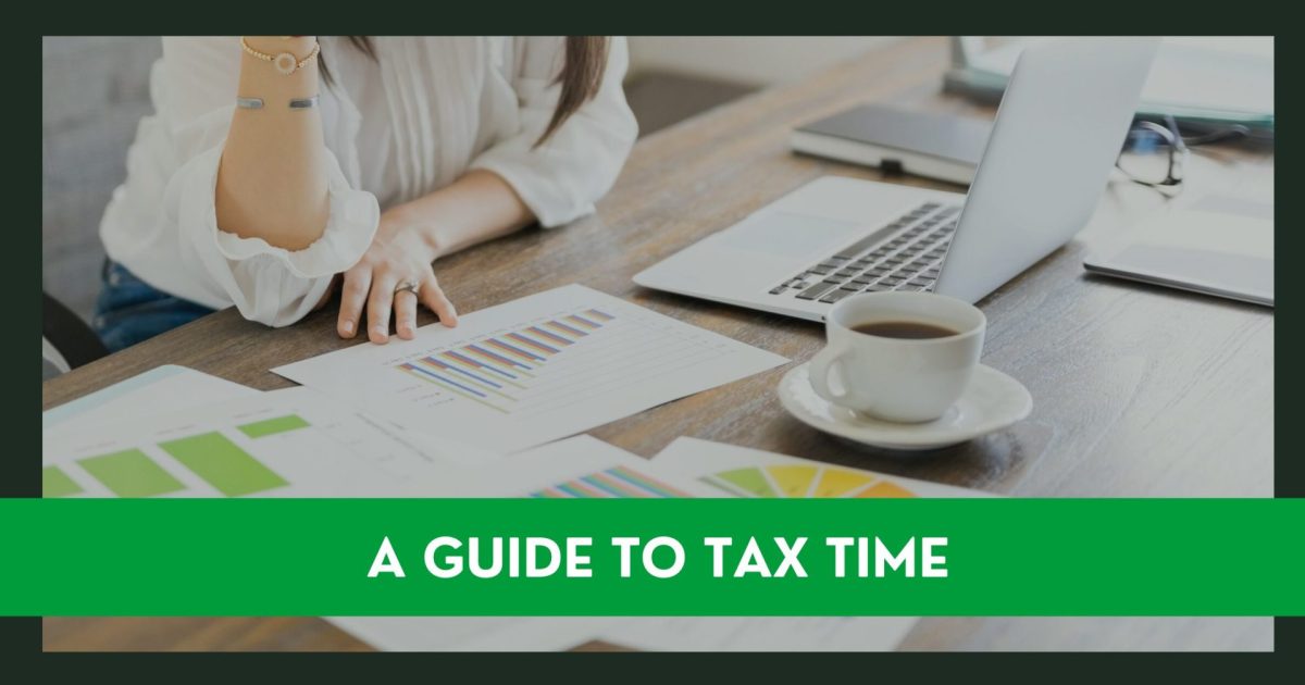 Tax preparation of w woman looking at paperwork and laptop to fill in a tax form return