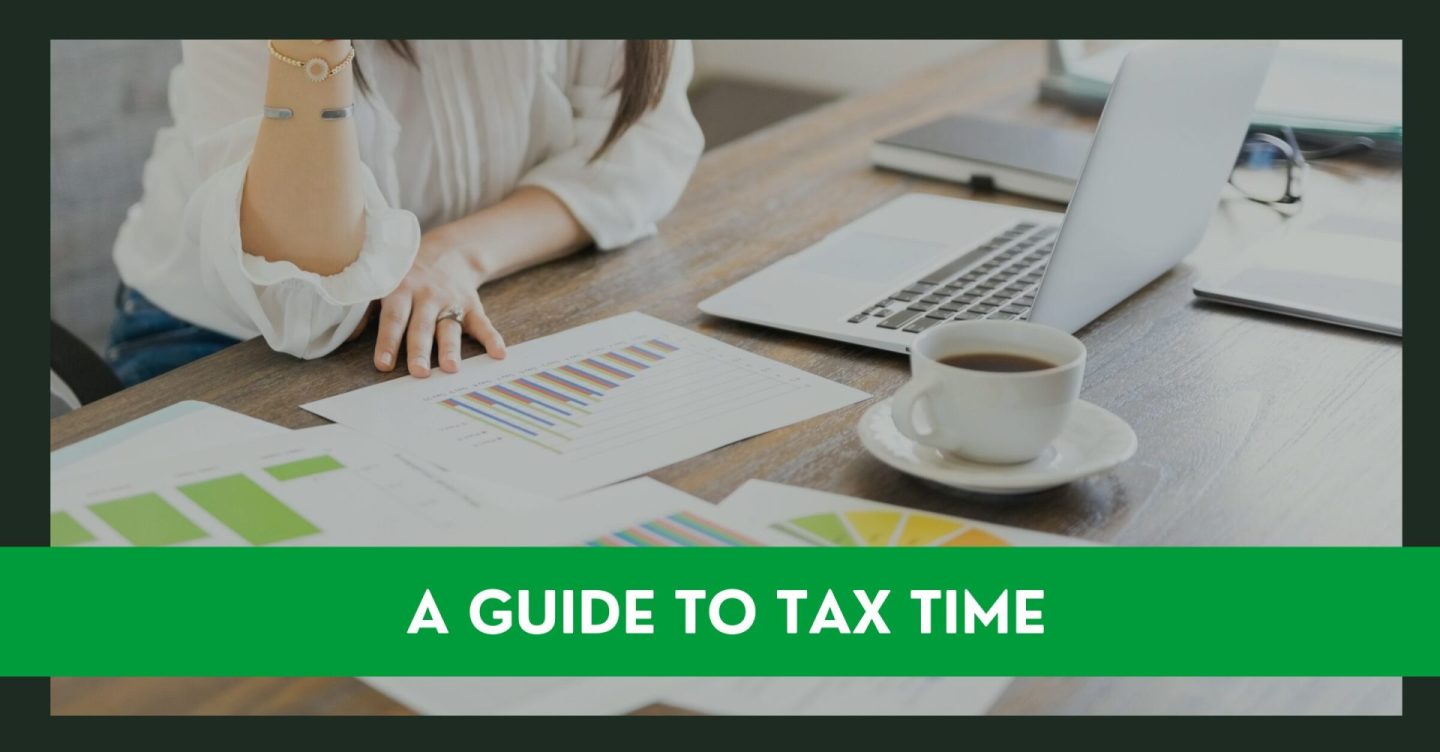 Tax preparation of w woman looking at paperwork and laptop to fill in a tax form return