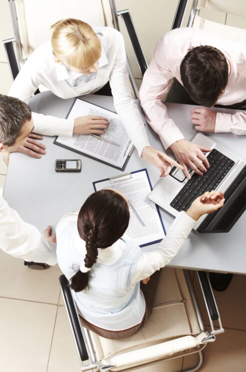 Staff Australia Employment Services 9 Meeting corporate birdseye view: Executives discussing strategies in a modern boardroom