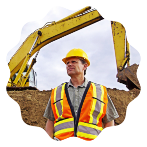 a FIFO worker in a hard hat and safety vest standing in front of an excavator