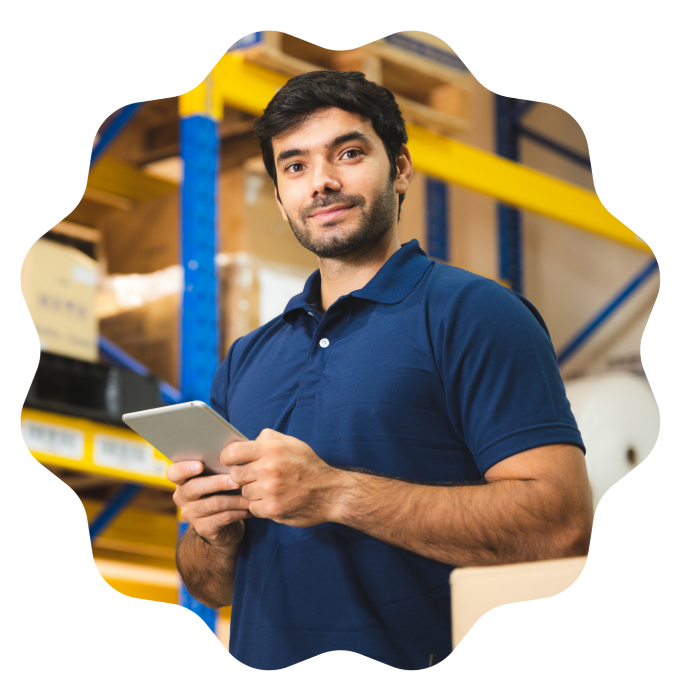 A young operations manager standing in a warehouse using a tablet