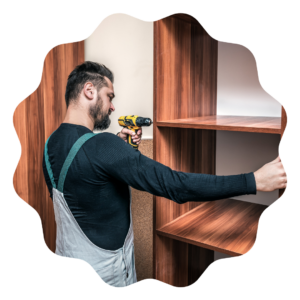 a man in overalls is holding a drill to assemble a wooden shelf