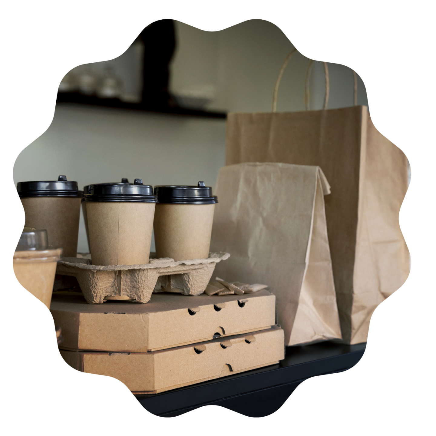 several coffee cups and paper bags on a table